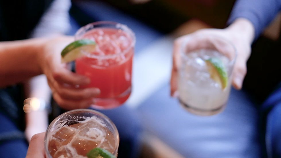 Friends toasting with margaritas at Don Pisto's